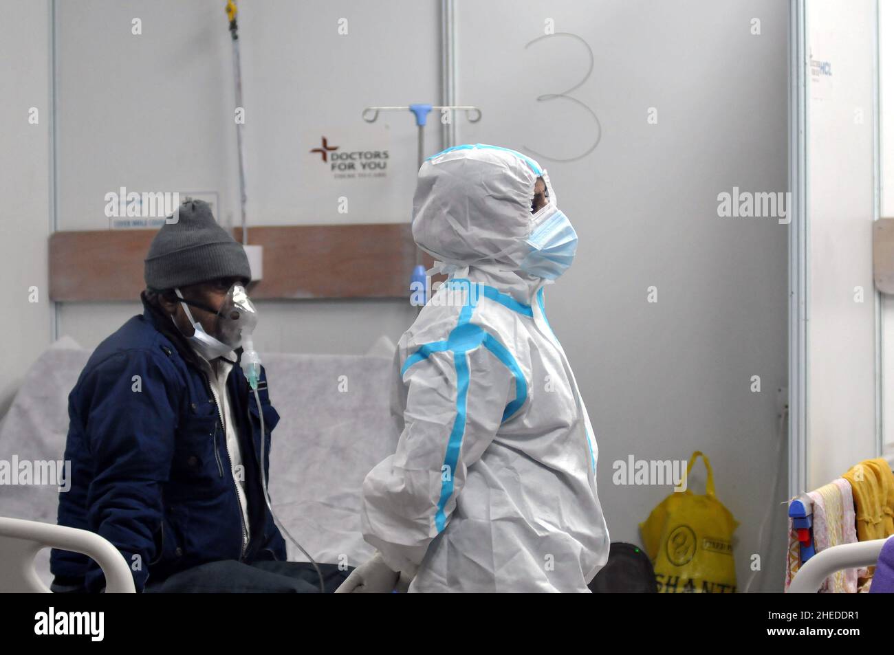 A patient is treated in the specialized isolation area to treat patients infected with Covid-19 disease, after the increase in positive cases for the new variant Omicron. On January 10, 2022 in New Delhi India. (Photo by Ravi Batra/ Eyepix Group) Stock Photo