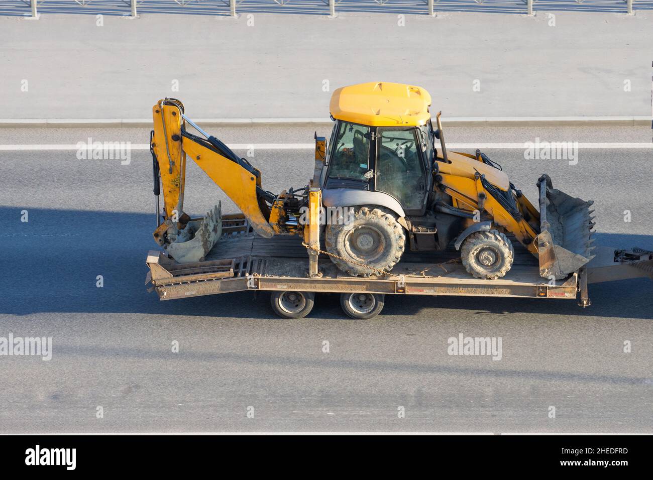 Loaded tractor with a bucket on a trailer platform Stock Photo Alamy