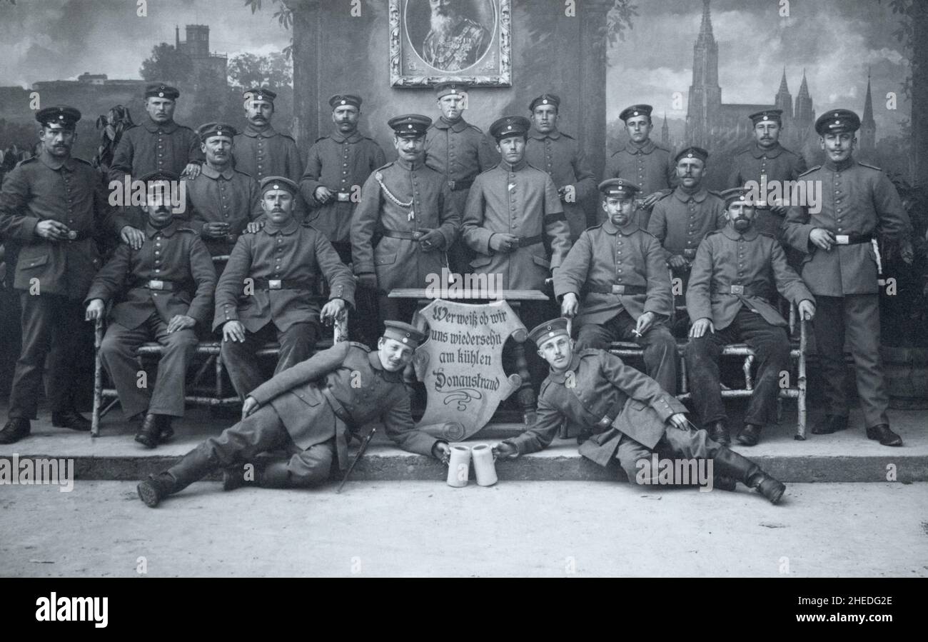 A First World War era grouip of German infantry soldiers of the 12th Royal Bavarian Infantry 'Prince Arnulf' Regiment, 2nd Royal Bavarian Division, I Royal Bavarian Corps. Picture taken in Neu-Ulm, Bavaria, Germany. The sign reads 'Wer weik ob wir uns wiedersehn am kühlen Donaustrand' which roughly translates to 'Who knows if we'll see each other again on the cool banks of the Danube'. Stock Photo