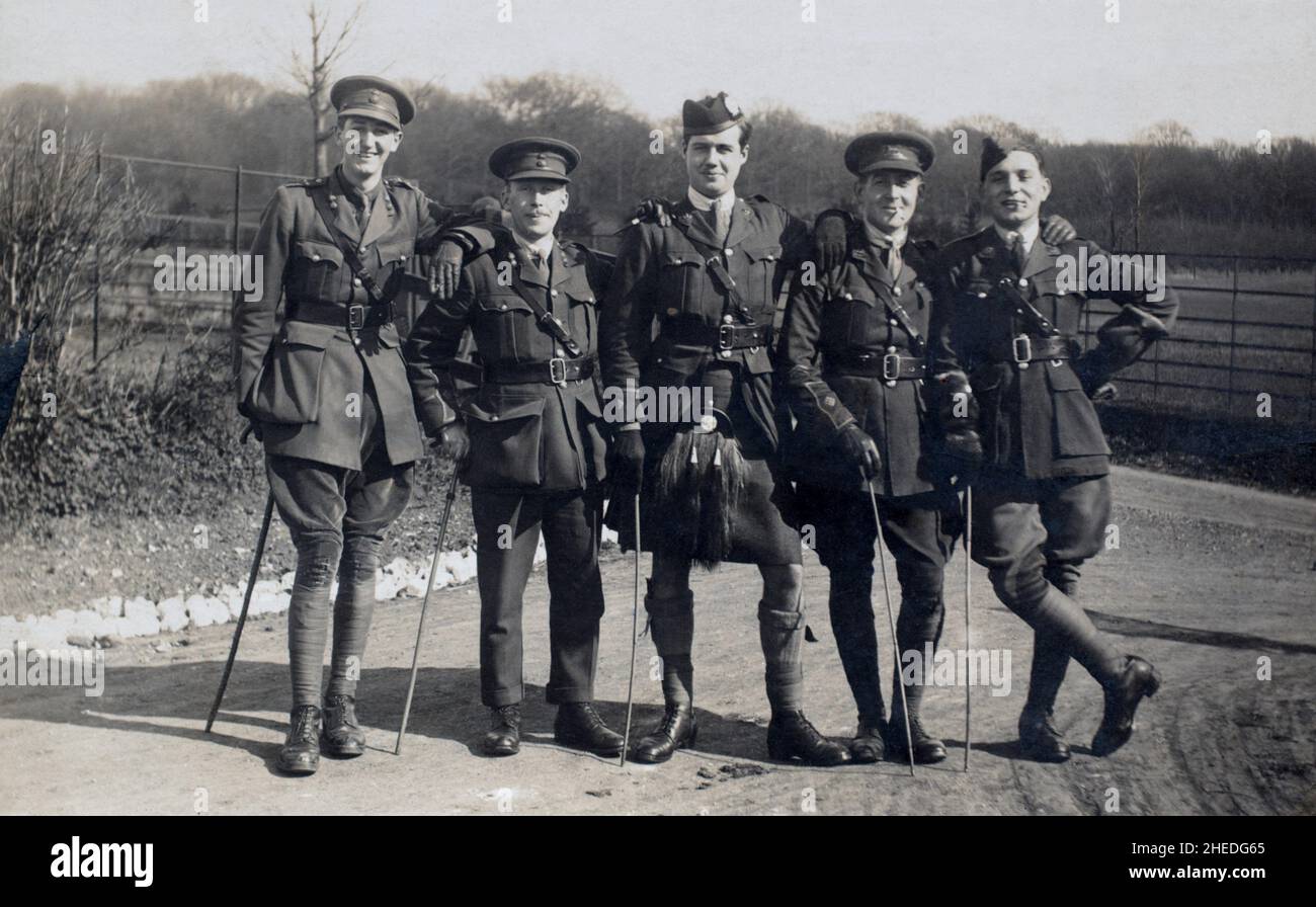 A First World War era grouip of British Officers standing informally as friends and smiling. Labelled by the photographer as 'my chums'. From left to right: 'Slim' - Royal Welsh Fusiliers; 'Tiny - Royal Welsh Fusiliers; 'Jock' - London Scottish Regiment; Parker - The Queen's (Royal West Surrey) Regiment; Jack - Royal Flying Corps. Stock Photo