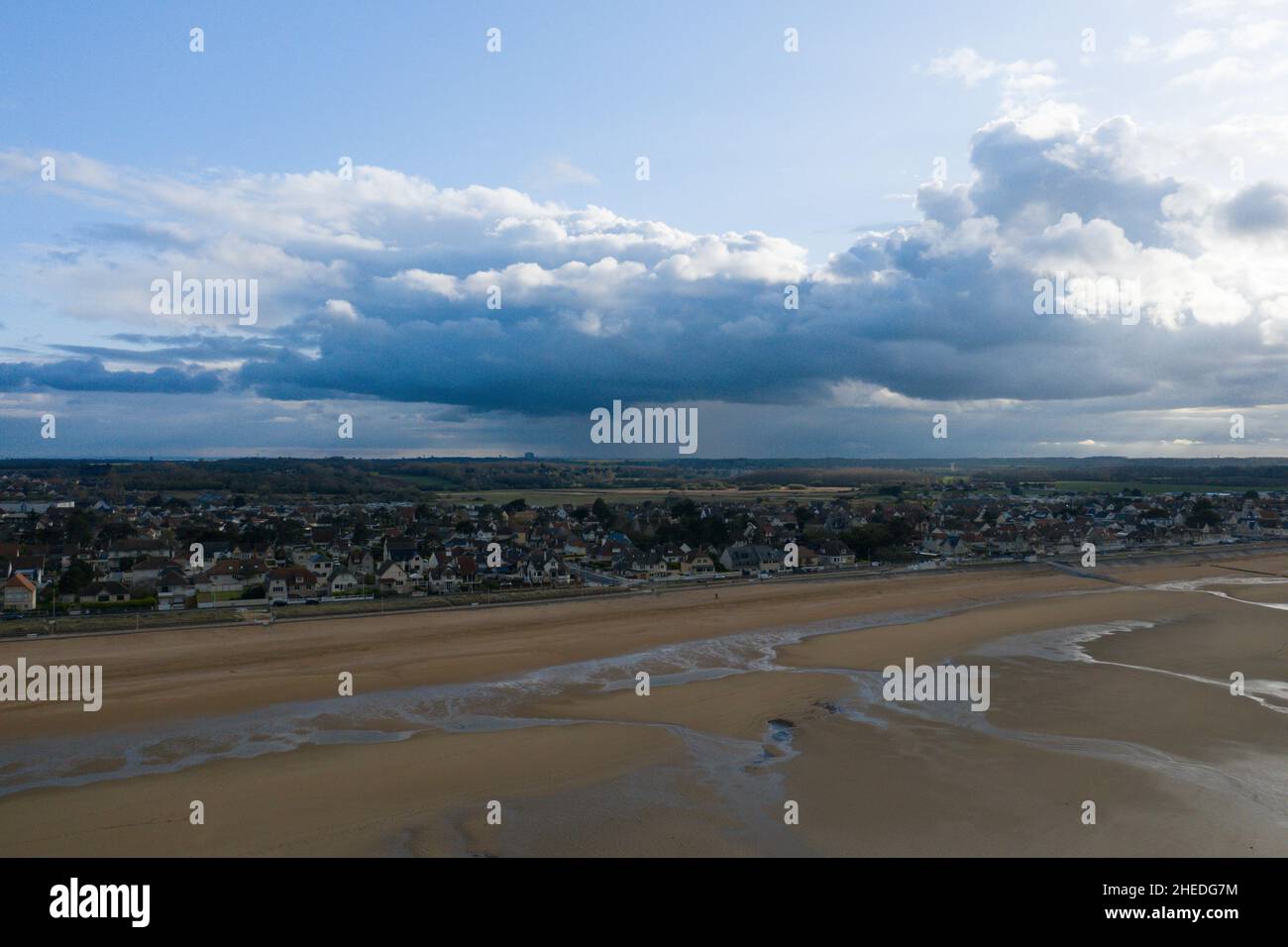 This landscape photo was taken in Europe, France, Normandy, Ouistreham, in summer. We see the city of Ouistreham at the edge of the fine sand beach, u Stock Photo