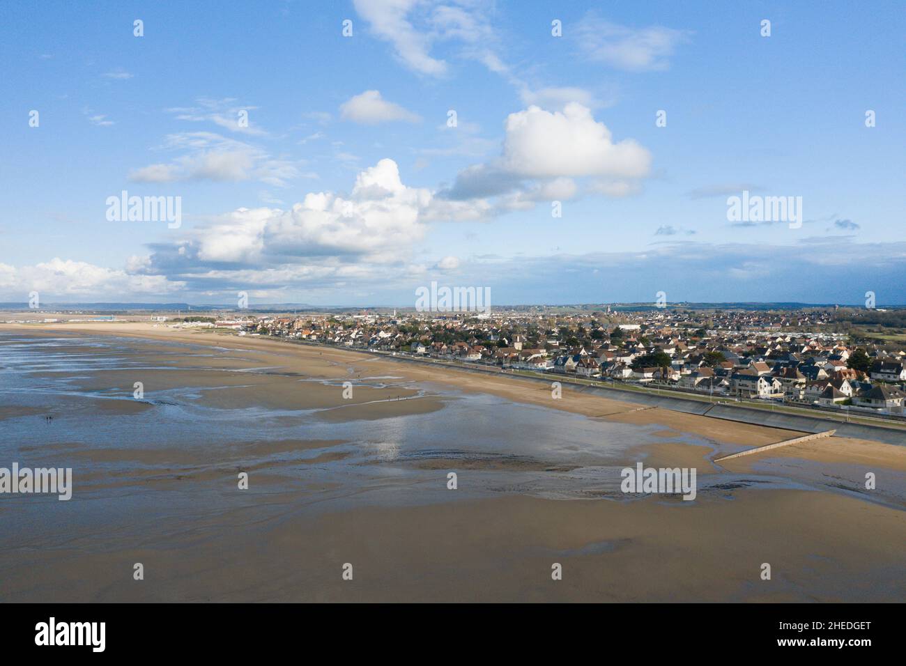 This landscape photo was taken in Europe, France, Normandy, in summer. We see the city of Ouistreham at the edge of the fine sand beach, under the Sun Stock Photo