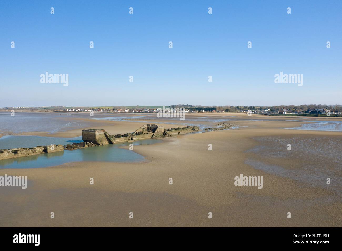 This landscape photo was taken in Europe, France, Normandy, Arromanches les Bains, in summer. We can see the sandy beach and the artificial port of Go Stock Photo