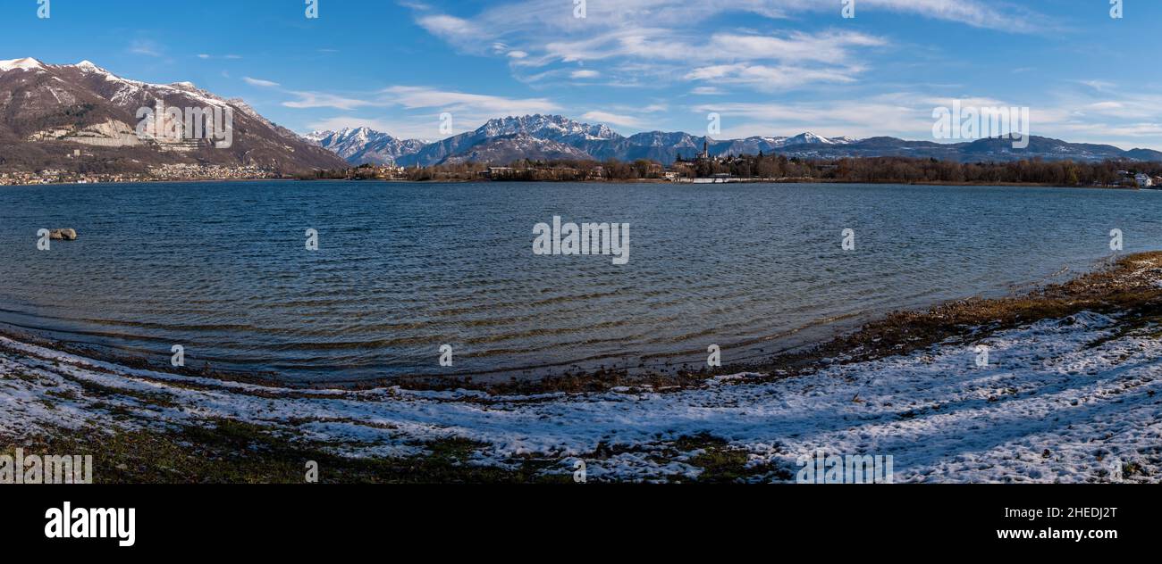Panorama shot of a mountain lake with view of Alps snow in Italian winter, Lake Como, Lombardy, Italy Stock Photo
