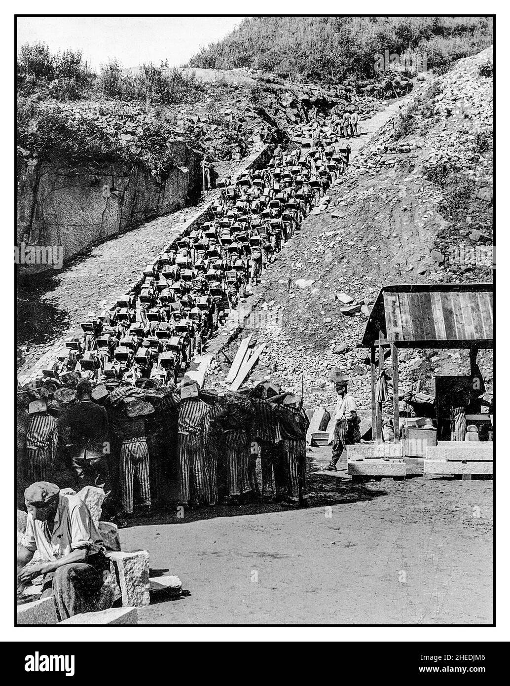 Nazi German death camp Mauthausen-Gusen (1938-1945) in Austria. Prisoners in the quarry (Stairs of Death). Prisoners were forced to carry giant granite boulders in order to supply stones for underground tunnels under Sankt Georgen an der Gusen town; such forced hard labour was like a torture. The American US Army liberated this death camp and shot commandant of the camp Franz Ziereis. Stock Photo