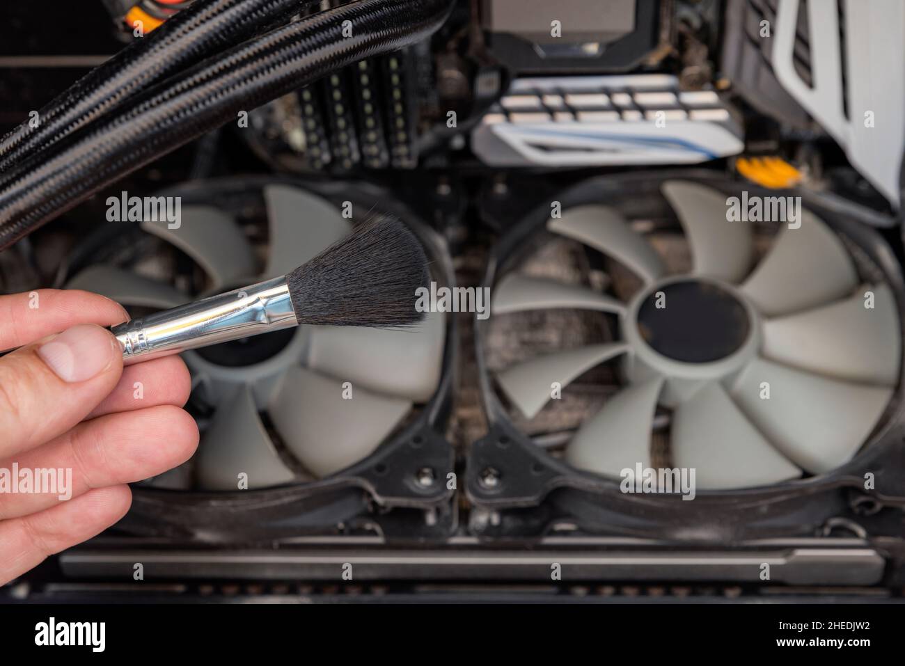 Cleaning the computer video card from dust with a brush and air. Computer fans in dust Stock