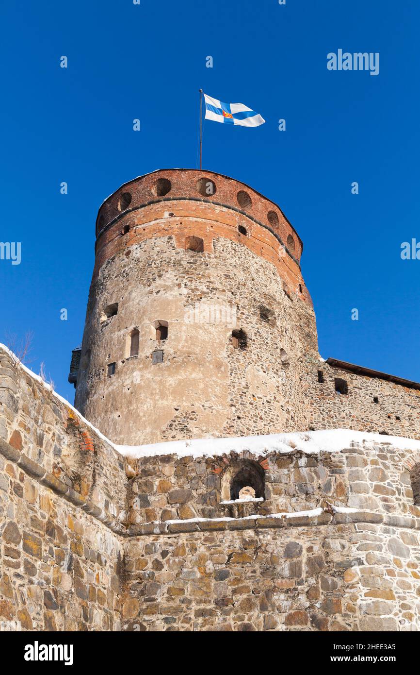 Olavinlinna is under blue sky, vertical photo. It is a 15th-century three-tower castle located in Savonlinna, Finland. The fortress was founded by Eri Stock Photo