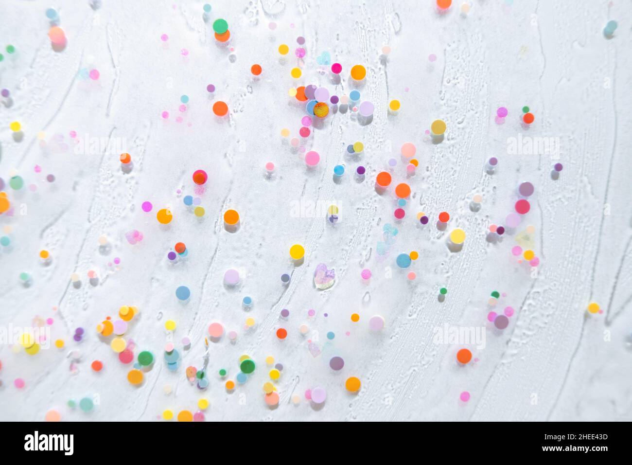 Abstract rainbow colored glitter particles. Macro Stock Photo