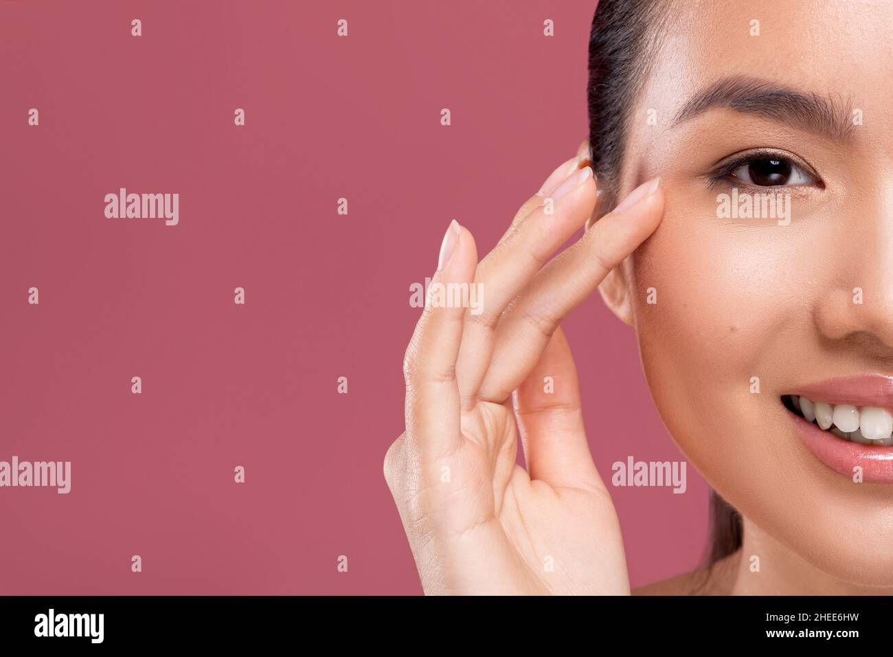 Half face of korean lady enjoying her beauty routine Stock Photo