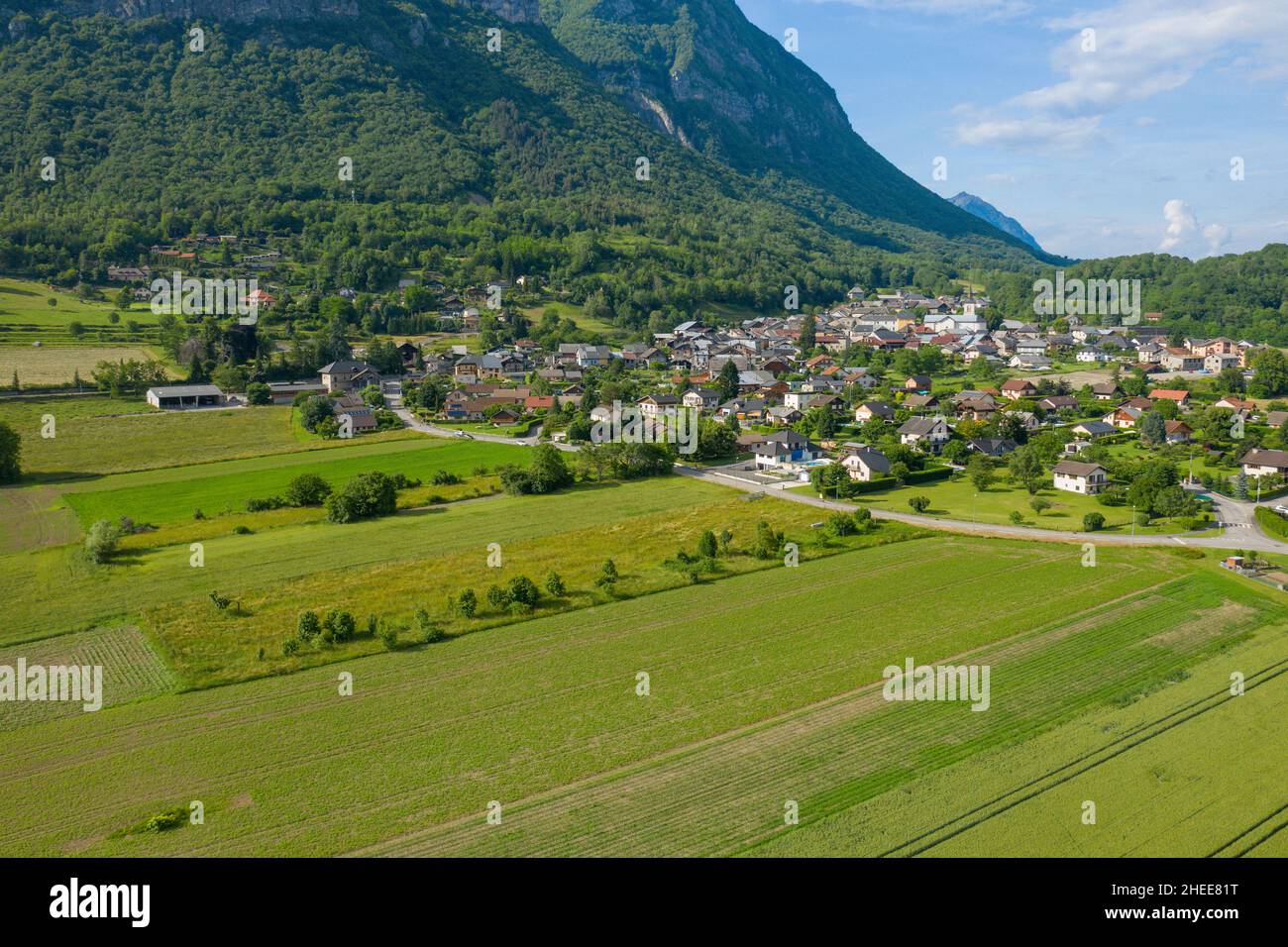 This landscape photo was taken in Europe, in France, in Isere, in the Alps, in summer. We see the city of Gresy sur Isere at the foot of the mountain Stock Photo