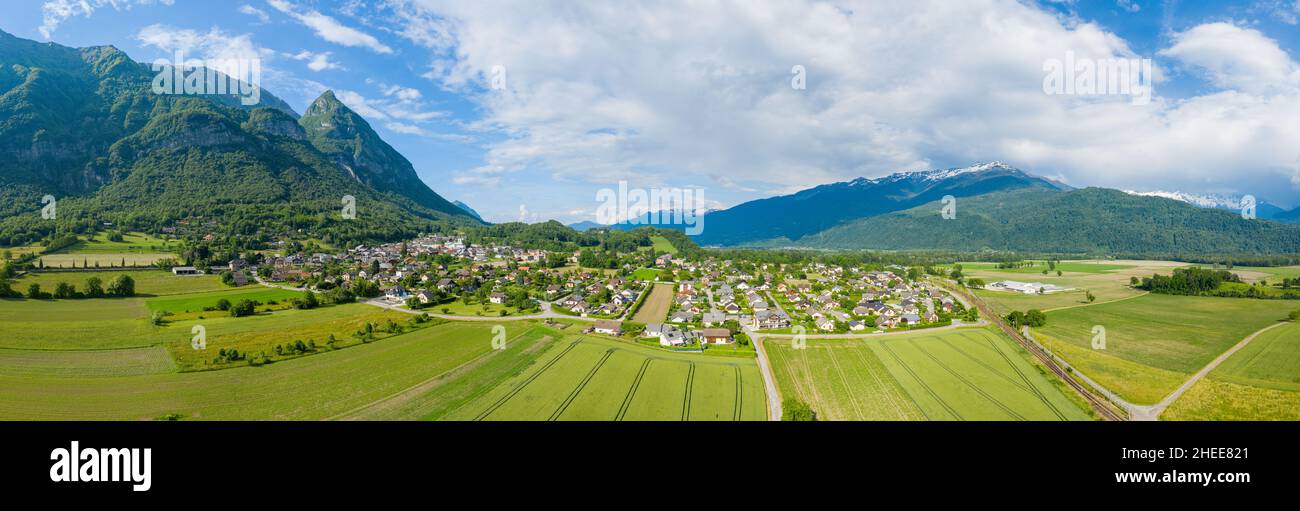 This landscape photo was taken in Europe, in France, in Isere, in the Alps, in summer. We see the panoramic view of the city of Gresy sur Isere, under Stock Photo