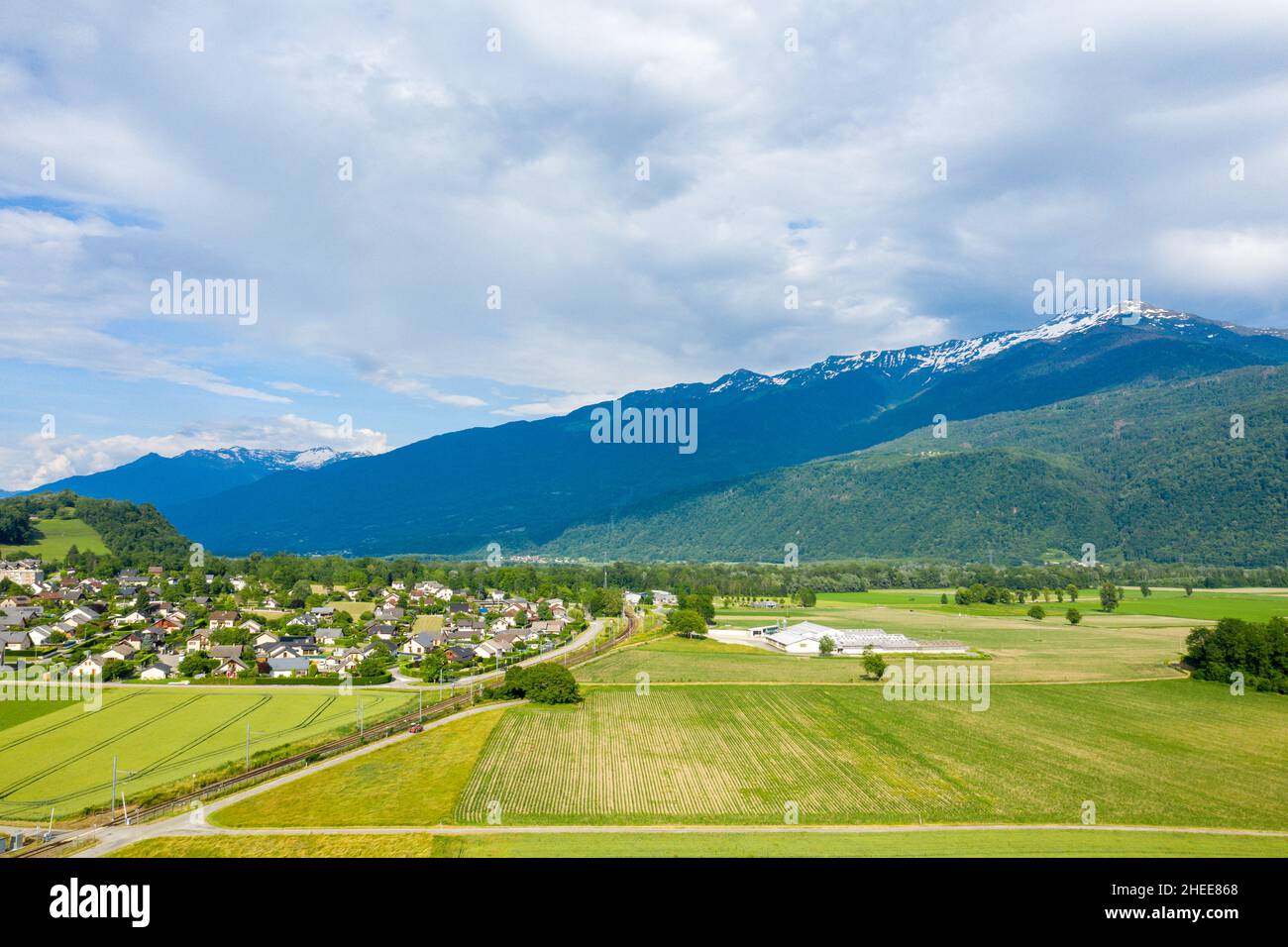 This landscape photo was taken in Europe, in France, in Isere, in the Alps, in summer. We see there The fields surround the town of Gresy sur Isere, u Stock Photo