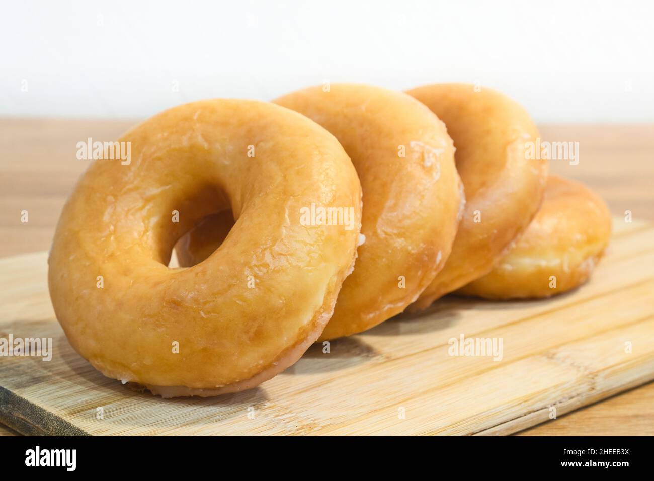 Homemade classic donuts on a on a wooden stand. Breakfast concept. Stock Photo