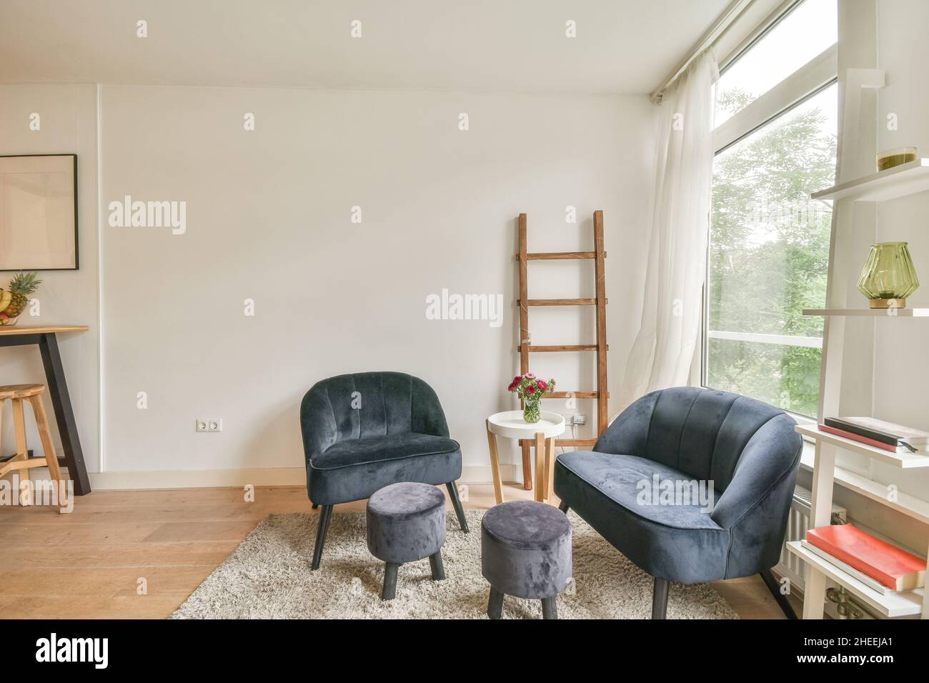 Interior of spacious light living room with small chairs and