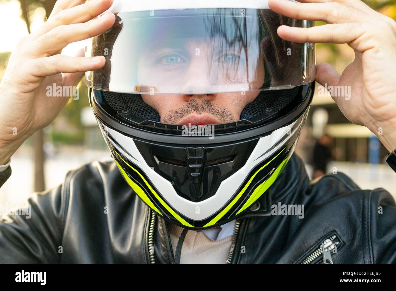 Motorcyclist putting on helmet hi-res stock photography and images - Alamy
