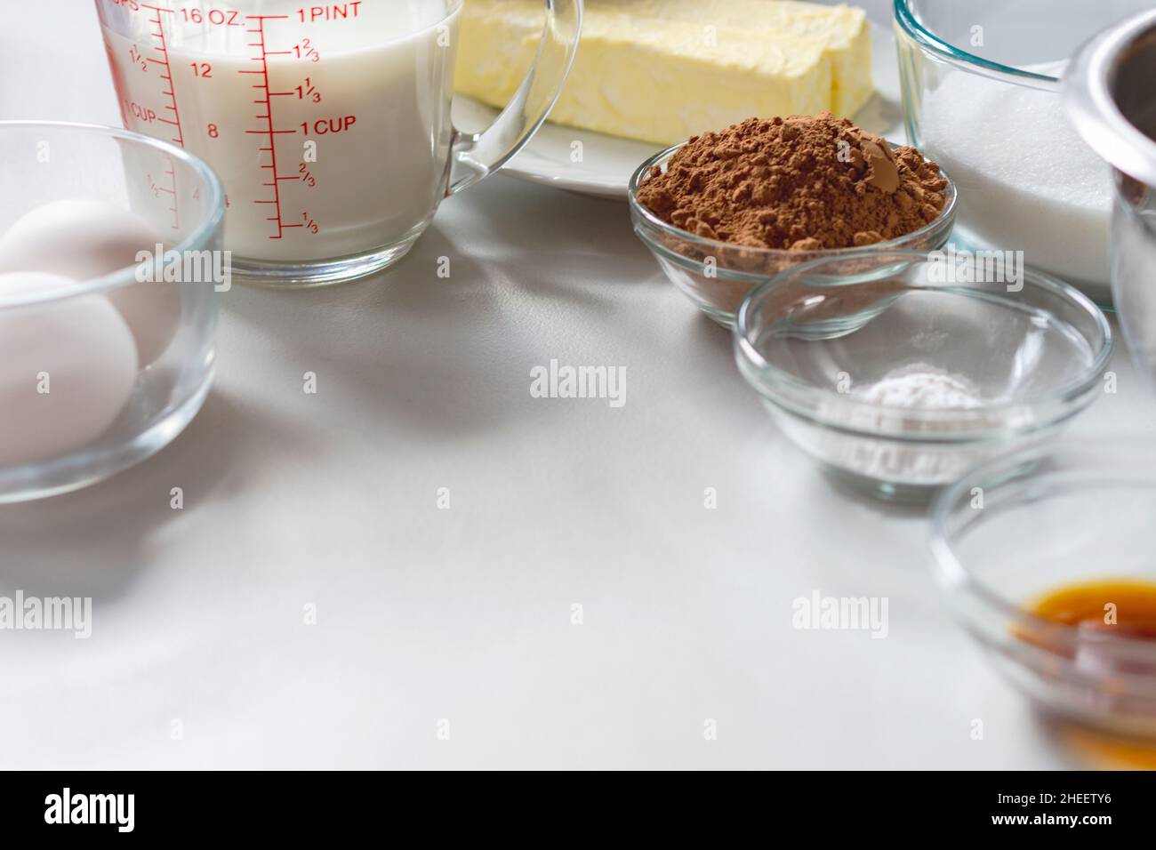 Various ingredients for baking arranged at the top of photo. Copy space