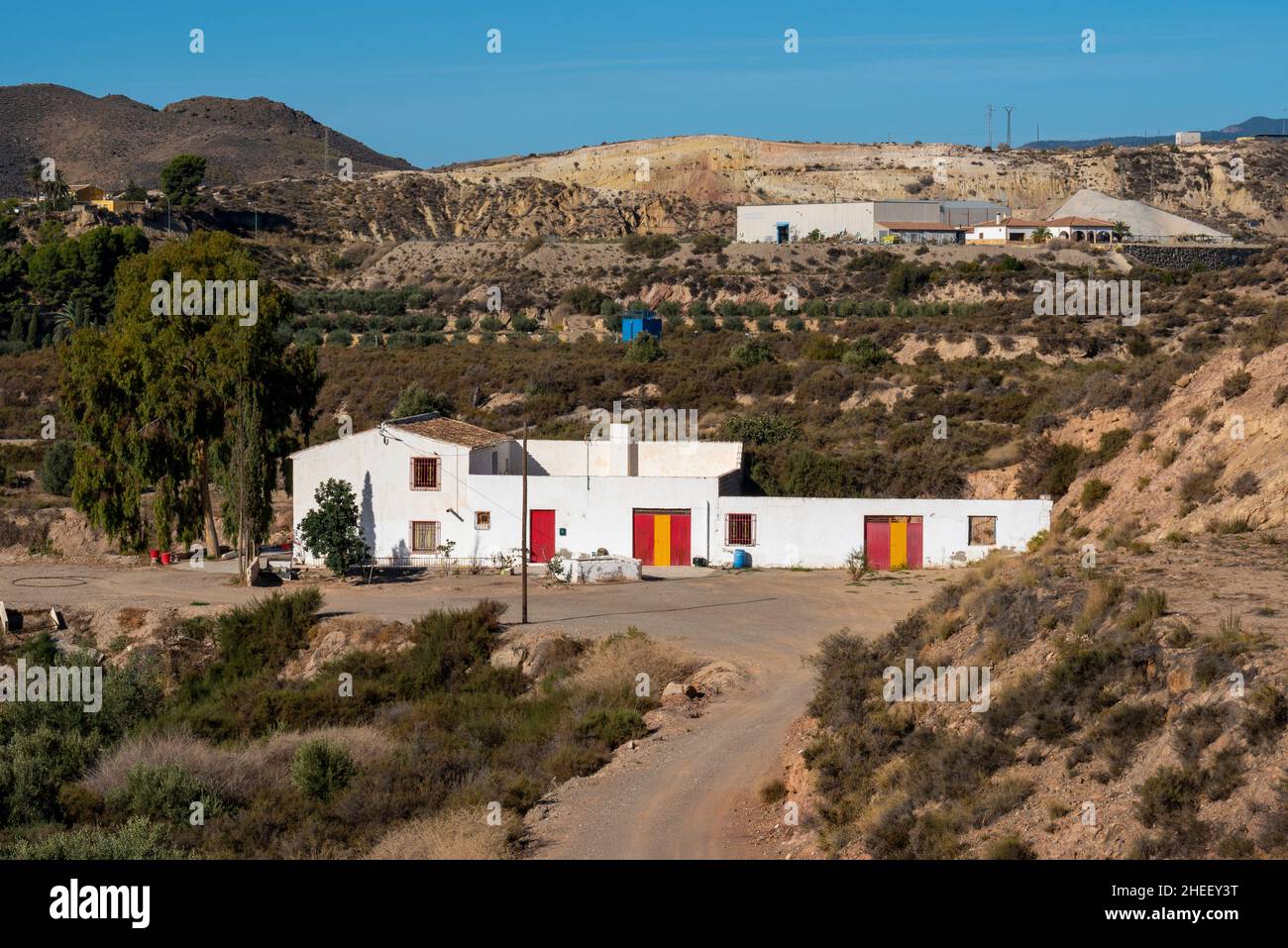 Hillside and valley properties outside Albox, Almeria, Andalusia, Spain. Rural, countryside farmhouse cortijo homes. Spanish colours on doors Stock Photo