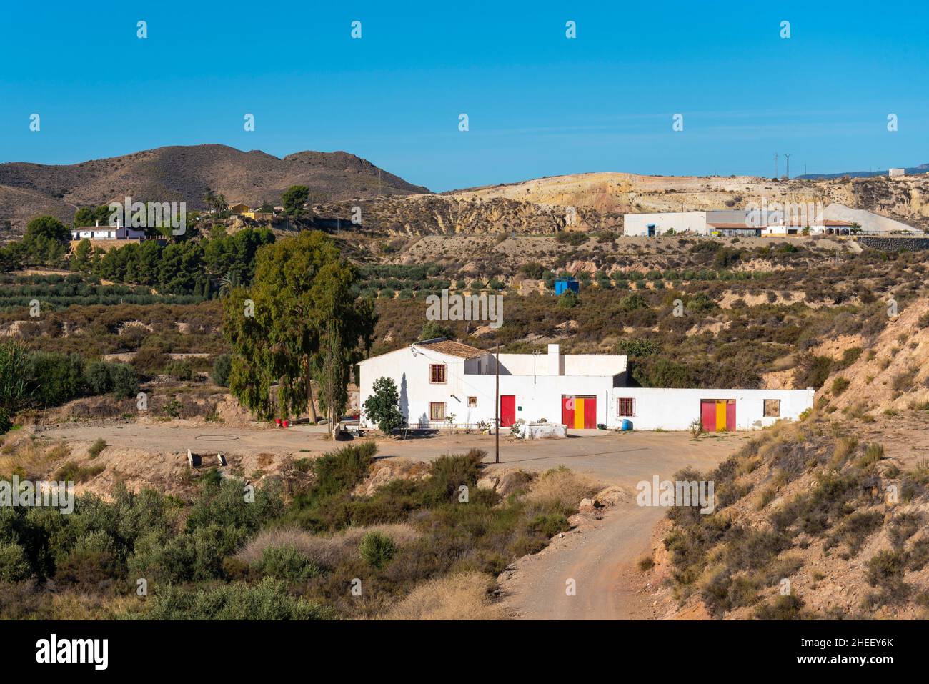 Hillside and valley properties outside Albox, Almeria, Andalusia, Spain. Rural, countryside farmhouse cortijo homes. Spanish colours on doors Stock Photo