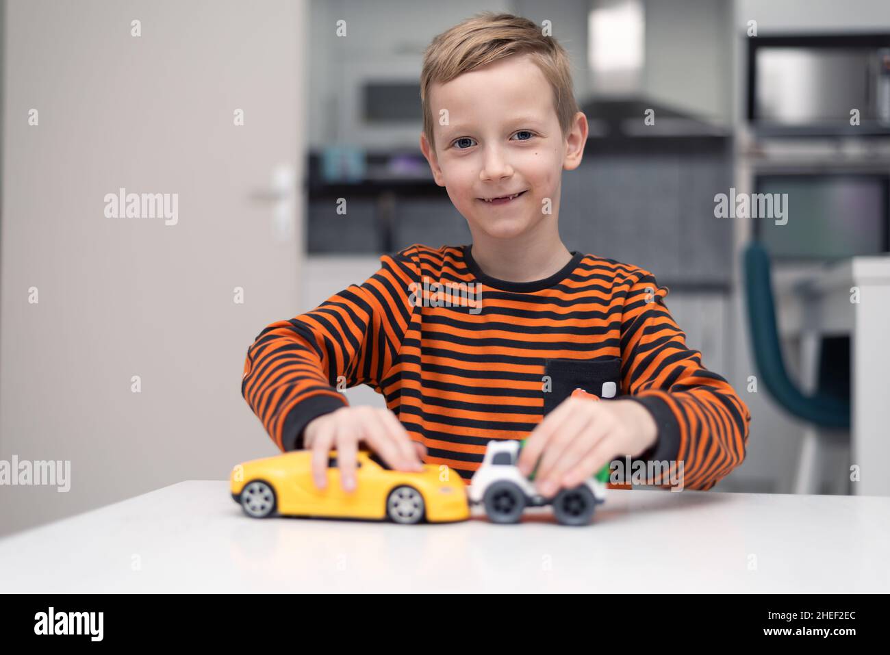 Boy playing toy cars. Kid with toys. Child and car at home Stock Photo ...