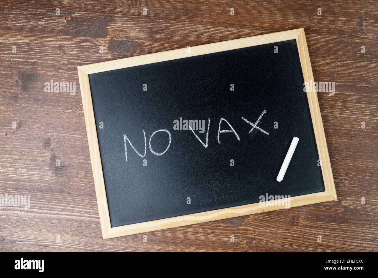the phrase No vax written with chalk on a blackboard Stock Photo