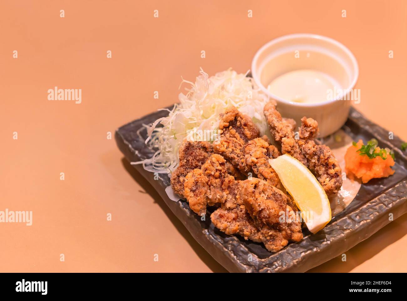 Japanese fish dish of battered and marinated fried whale made by adding