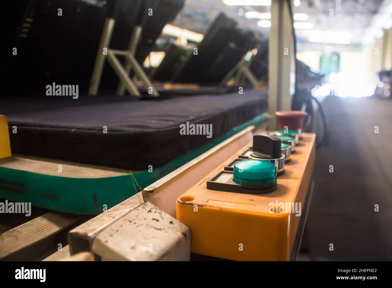 Control buttons installed at line conveyor for TV assembly line. Stock Photo