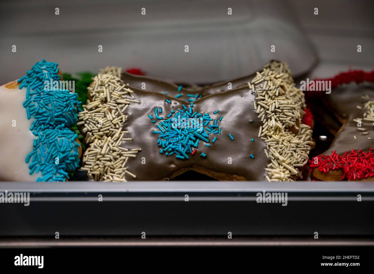 Sweet colorful bowshaped biscuits on display at Italian bakery Stock