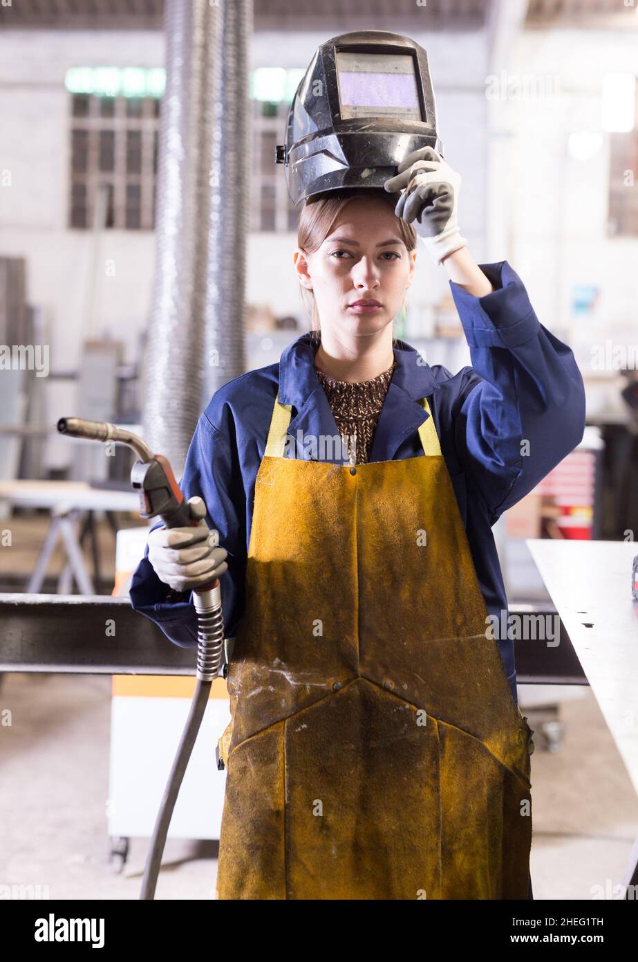 Young woman using welder for construction work Stock Photo Alamy