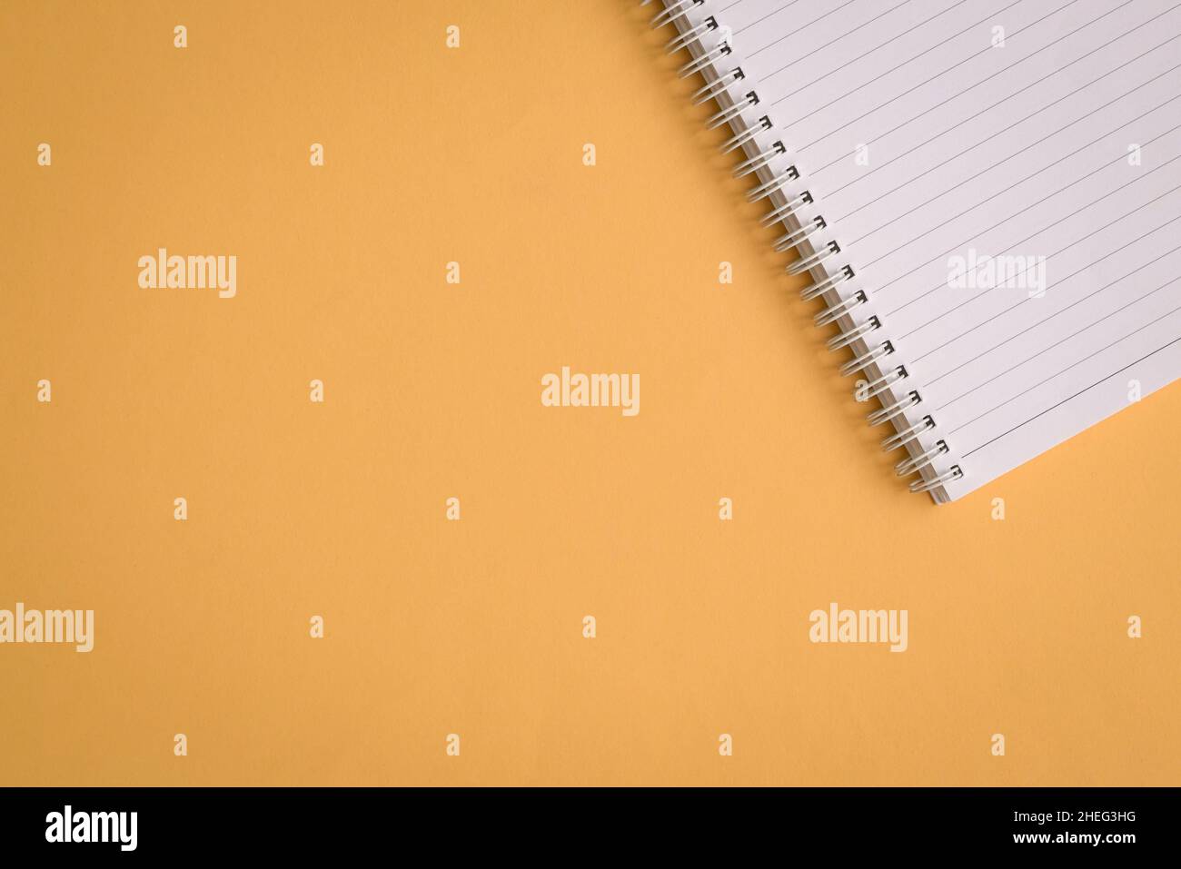 Blank notepad on yellow background. Copy space. Stock Photo
