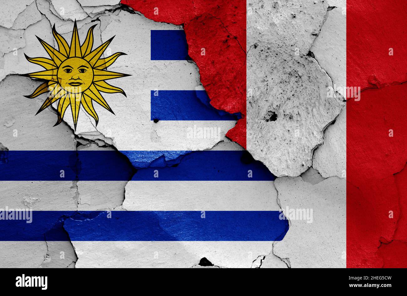 flags of Uruguay and Peru painted on cracked wall Stock Photo
