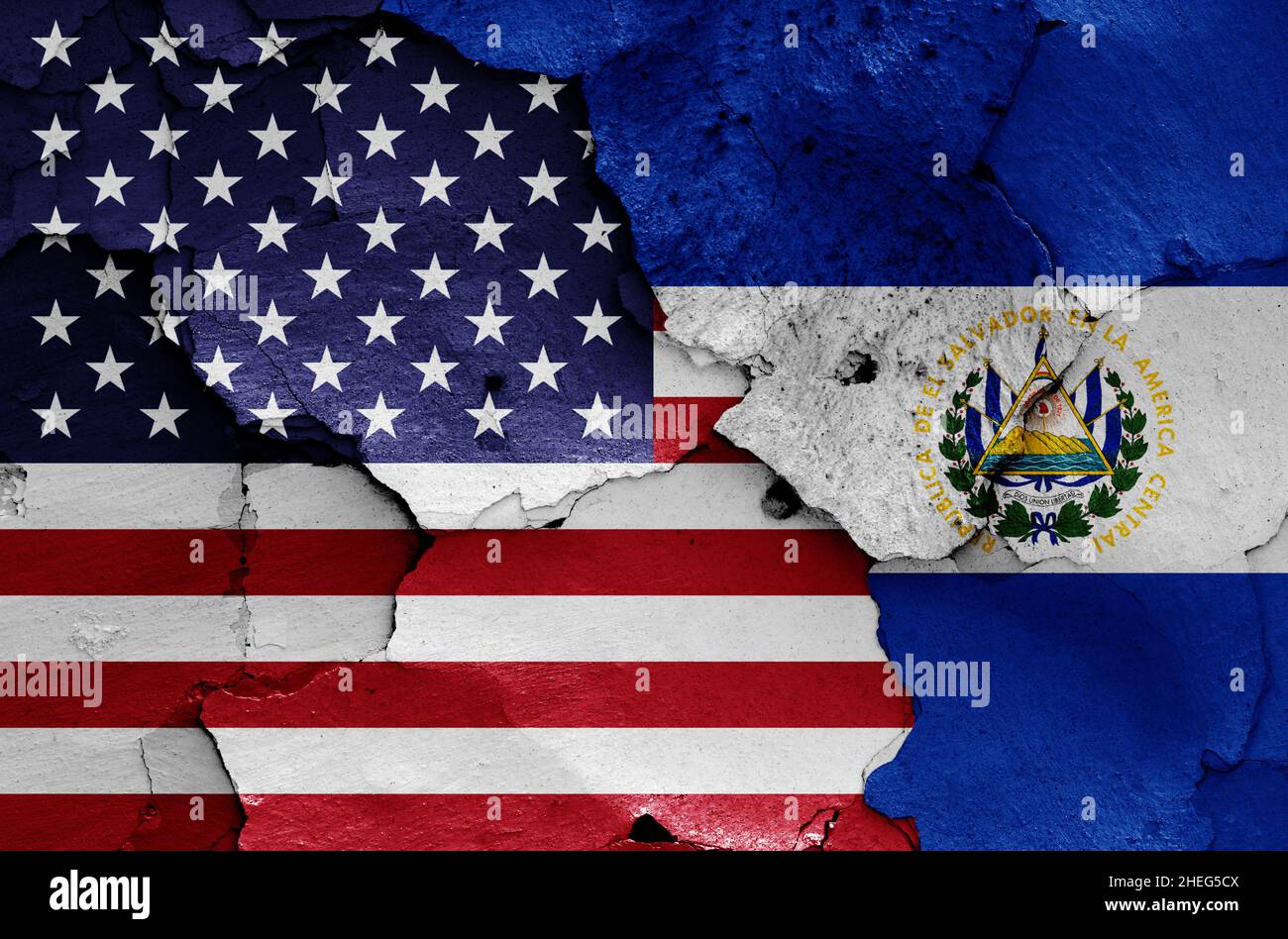 flags of USA and El Salvador painted on cracked wall Stock Photo
