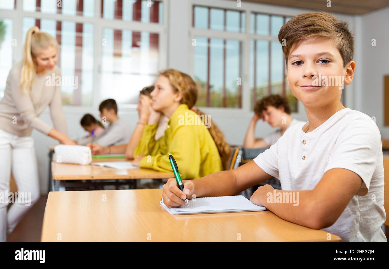 Schoolboy posing in classroom during lesson Stock Photo - Alamy