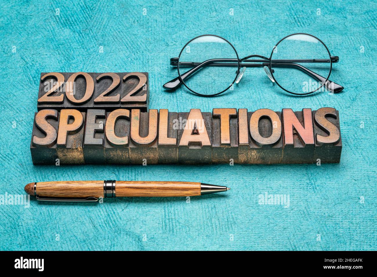 2022 year speculations concept - text in vintage letterpress wood type printing blocks with reading glasses, expectations and predictions for the New Stock Photo