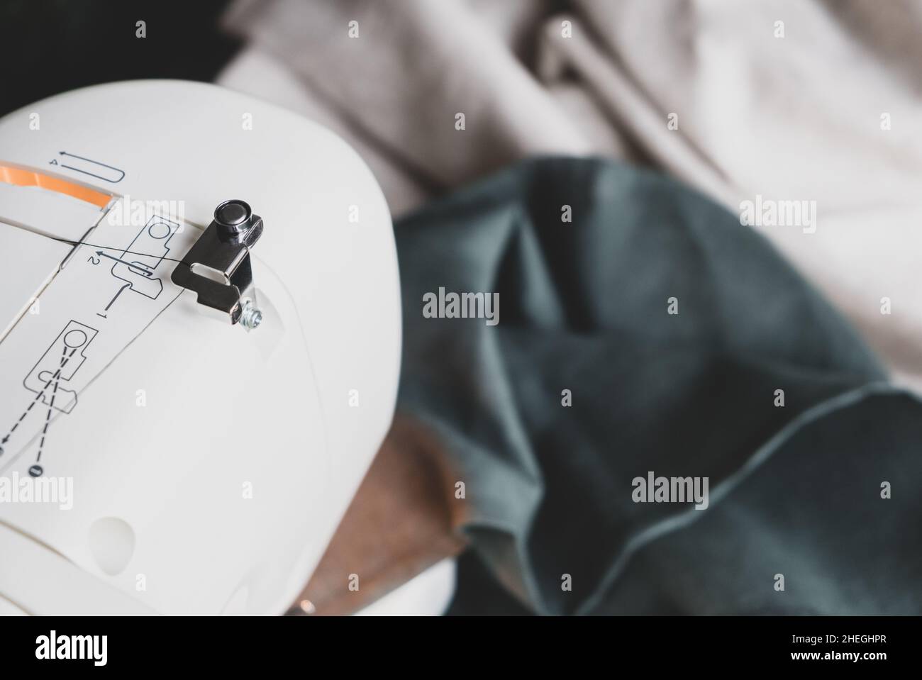 Sewing machine on a table in a sewing workshop, top view Stock Photo