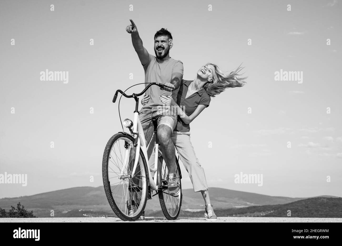 Couple in love riding a bike. Beautiful couple friend adolescents. Relationship. During summer holidays vacation. On the clouds of summer love. Summer Stock Photo