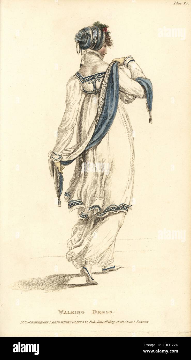 Walking dress: spotted muslin under-dress with a light coat bordered with cerulean blue. Blue silk headdress and scarf, bound with silver cords and tassels. York tan gloves. Plate 29, June 1809. Handcoloured copperplate engraving by Thomas Uwins from Rudolph Ackermann's Repository of Arts, London. Stock Photo