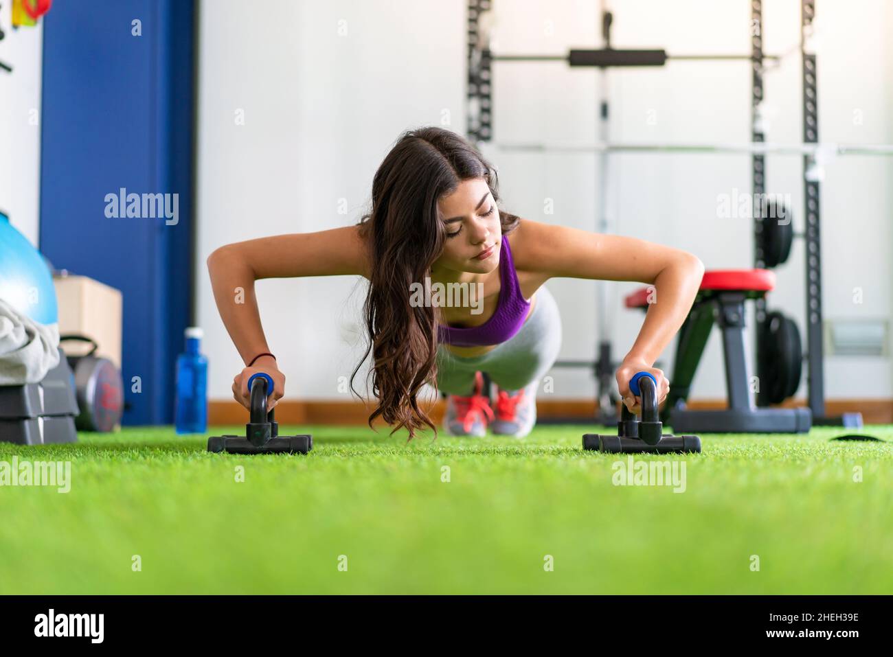 Young sport woman in a gym doing push-ups Stock Photo - Alamy