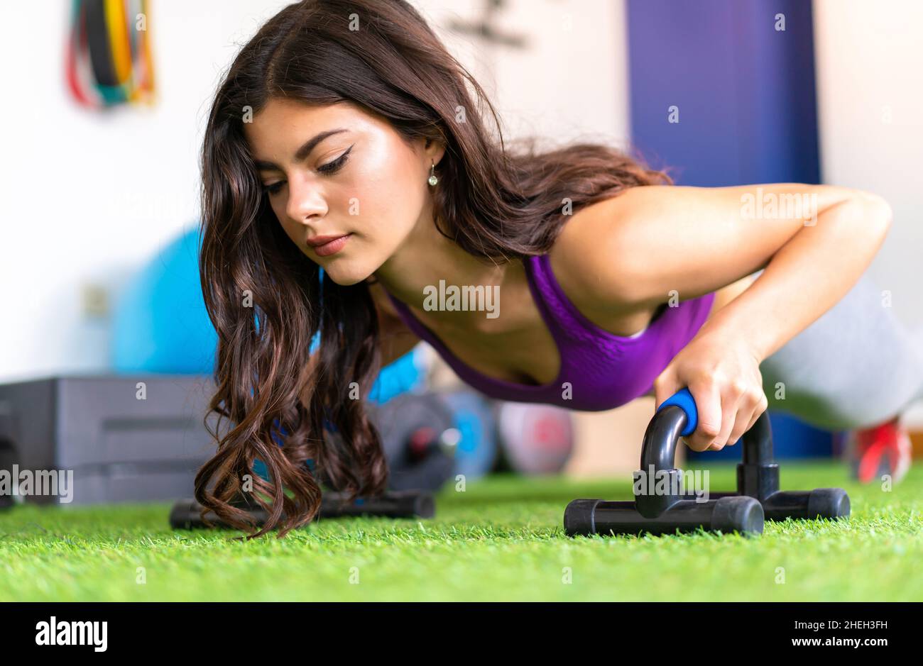 Young sport woman in a gym doing push-ups Stock Photo - Alamy