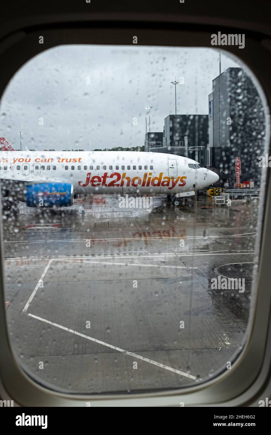 Jet 2 holidays plane seen through the window of a plane in the rain on