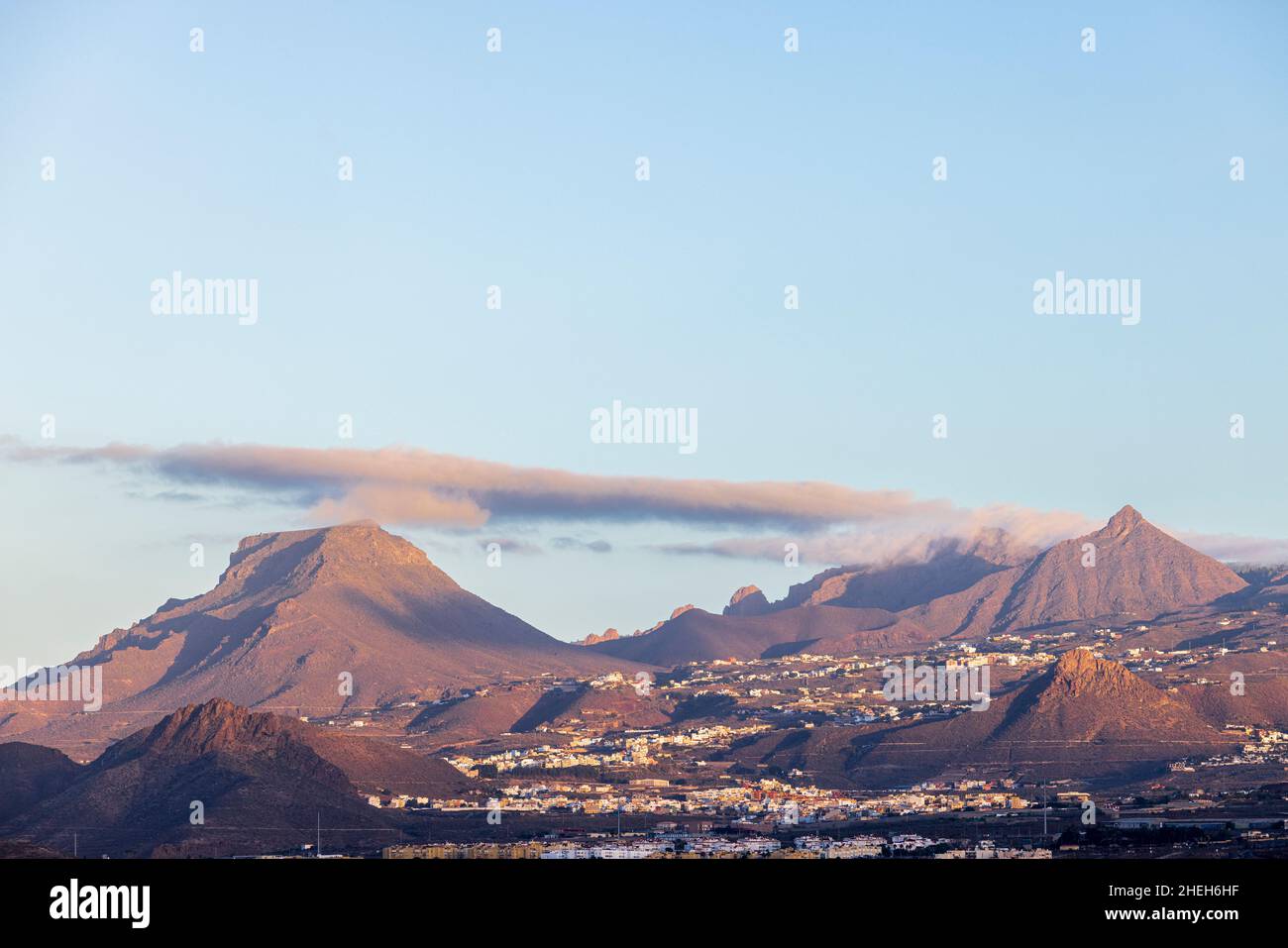 Dawn light on Roque del Conde and Roque Imoque seen from Costa Silencio on Tenerife, Canary Islands, Spain Stock Photo