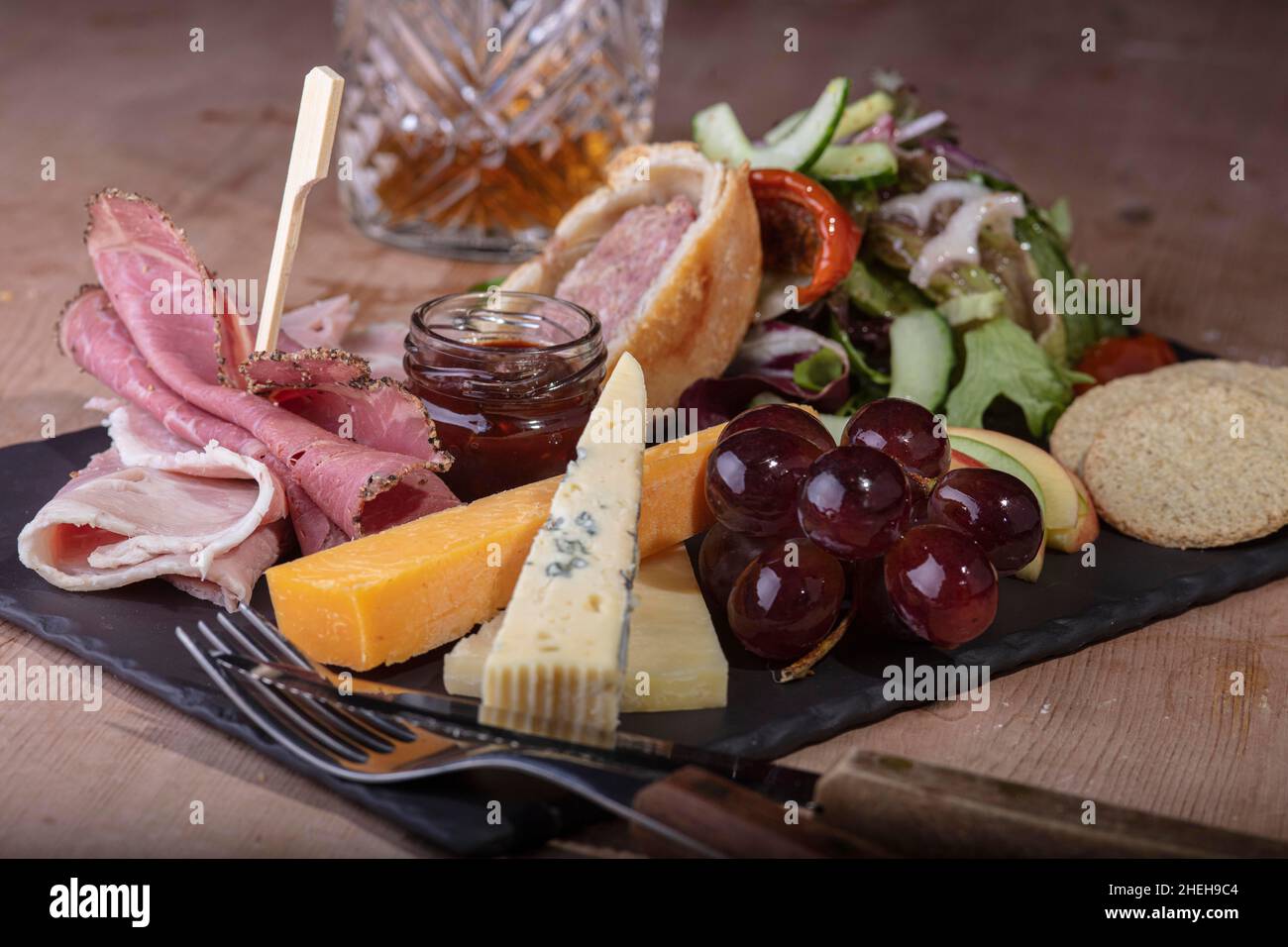 Ploughmans Lunch of meats and fruit. Stock Photo