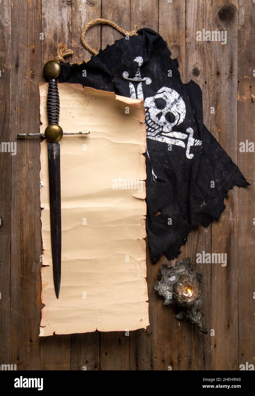 Pirate still life with jolly roger flag top view and blank scroll for card or text Stock Photo