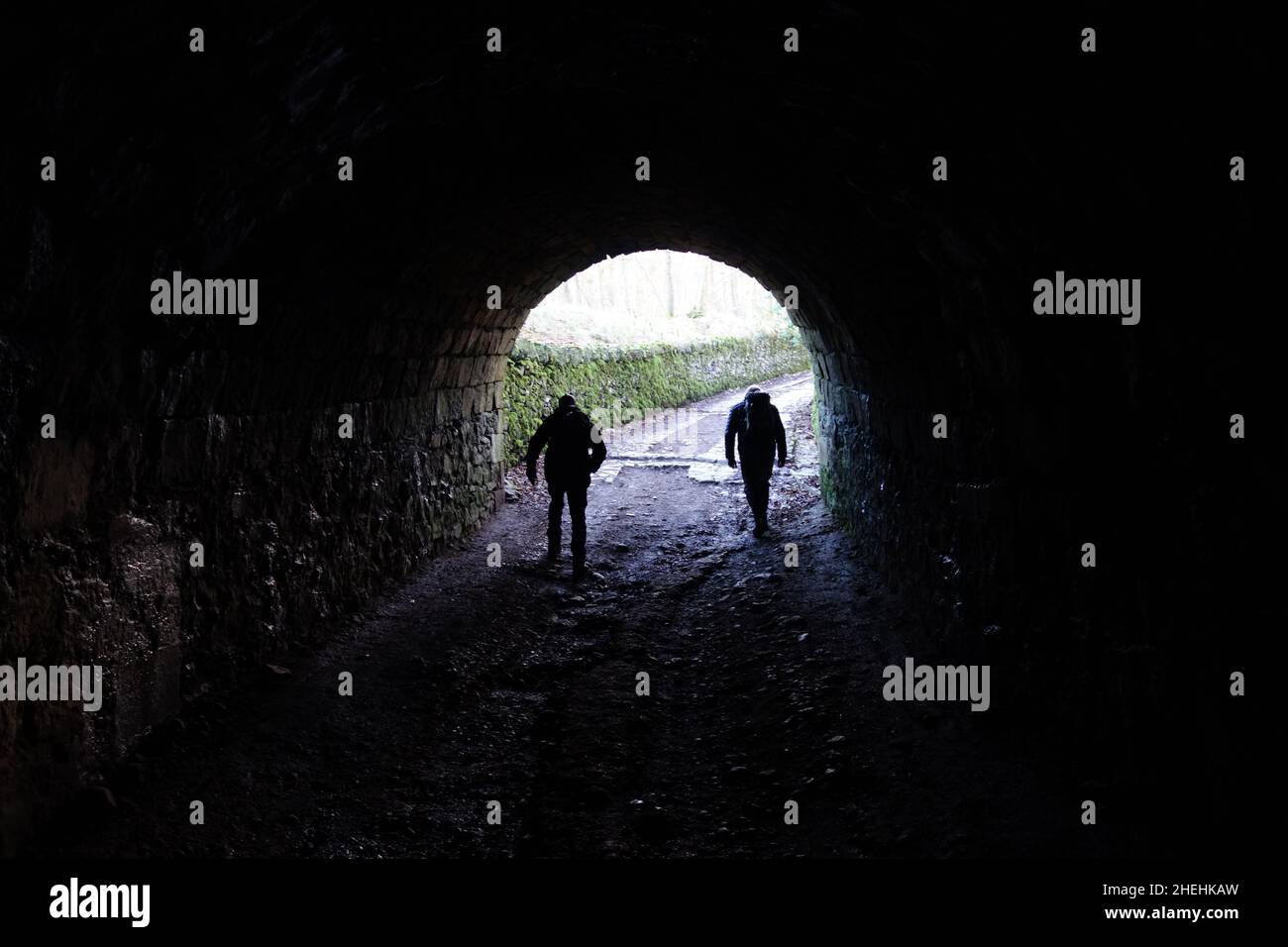 Two Men Walking in one of the Victorian Servants Tunnels for Ingleborough Hall Estate in Clapham, Yorkshire Dales National Park, England, UK. Stock Photo