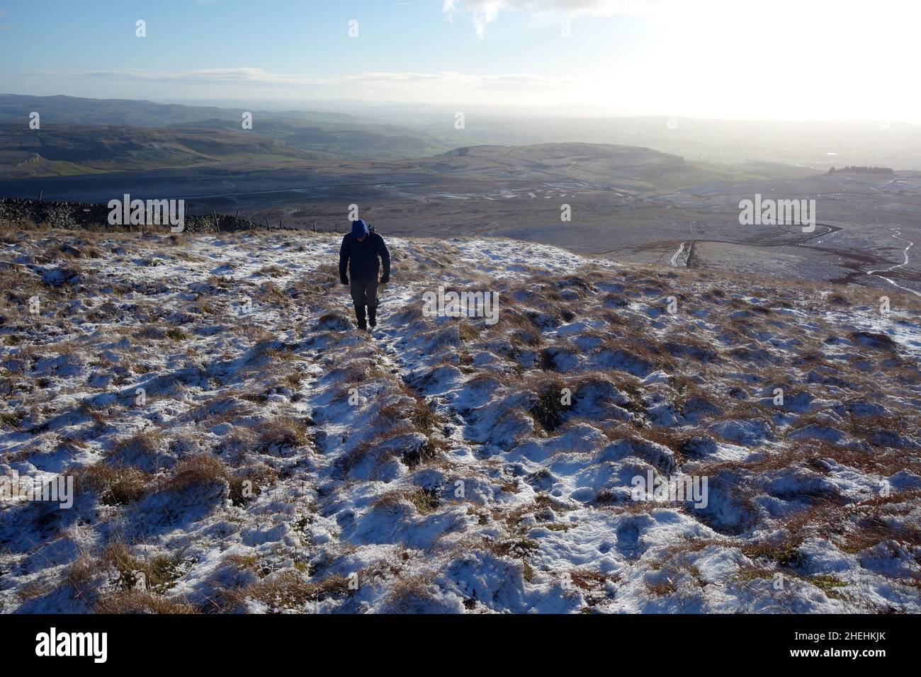 Lone Man Walking on Path to Simon Fell and Ingleborough (1 of the Yorkshire 3 Peaks) from Clapham, Yorkshire Dales National Park, England, UK. Stock Photo