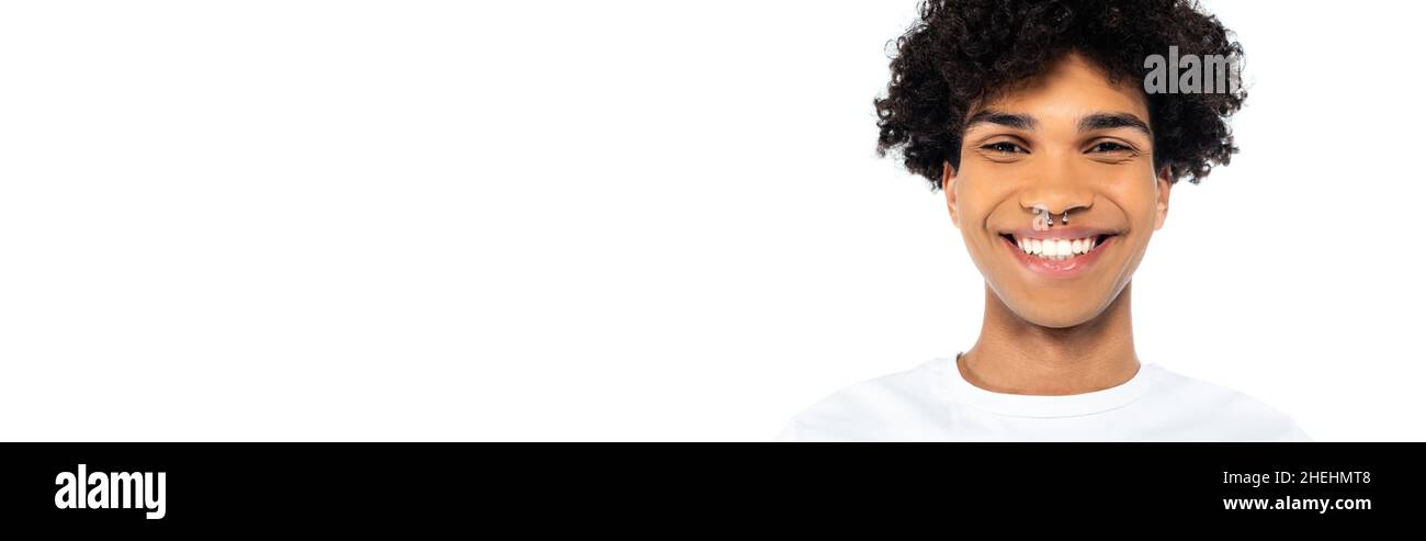 curly african american man with piercing smiling at camera isolated on white, banner Stock Photo
