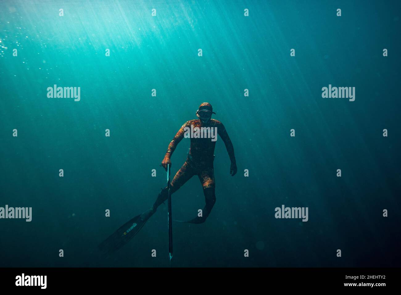 A man gets his spearfishing gear ready as the sun begins to set Stock Photo  - Alamy