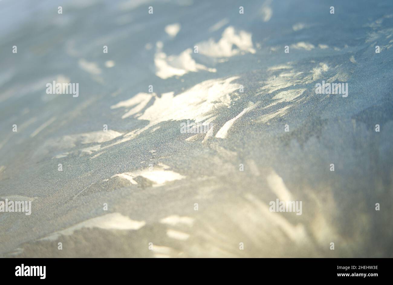 Patterns in ice on a car windscreen on a cold winter's morning Stock Photo