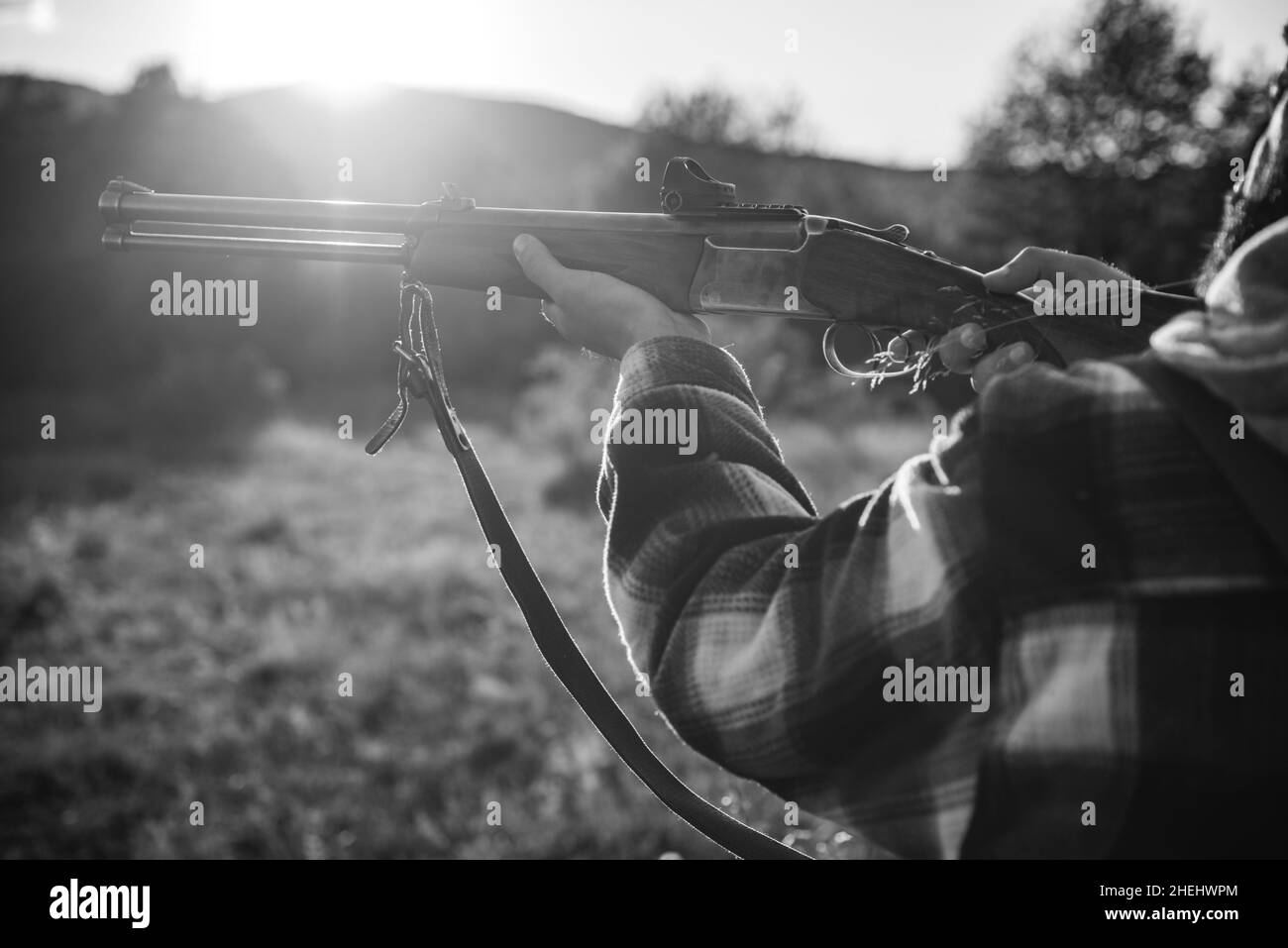 Hunter with shotgun gun on hunt. Illegal Hunting Poacher in the Forest. American hunting rifles. Hunting without borders. Stock Photo