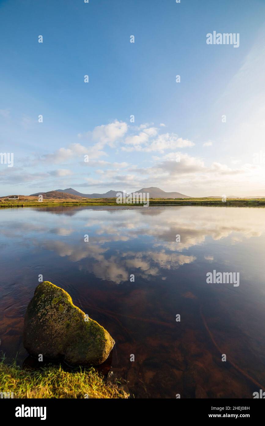 The hills of South Uist taken across beautiful calm waters from Howmore Stock Photo