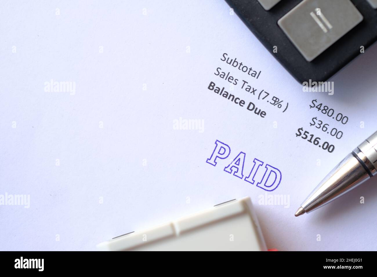 Paid invoice and Rubber Stamp on paper , Stock Photo